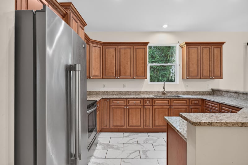 Kitchen counter with stainless fridge and tile floor at 1012 Fruit Cove Rd, Jacksonville, FL 32259