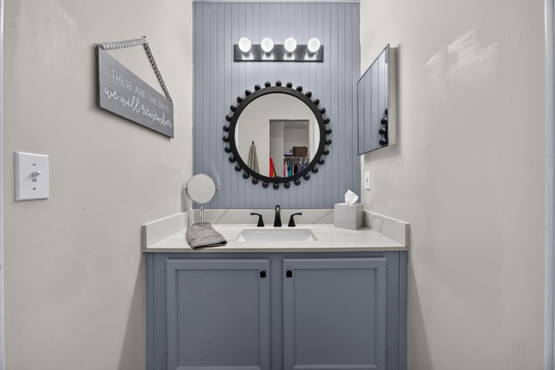 Bathroom vanity with patterned wallpaper at 3067 Wavering Ln, Middleburg, FL 32068
