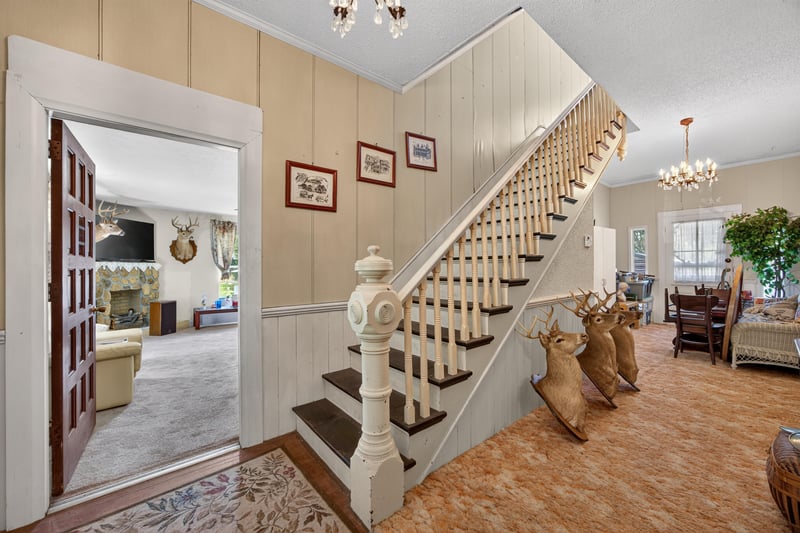 Hallway view toward staircase and front rooms at 1173 US-17, Satsuma, FL 32189
