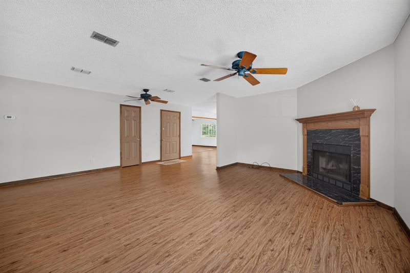 Family room with brick fireplace and vaulted ceiling at 892 Branscomb Rd, Green Cove Springs, FL