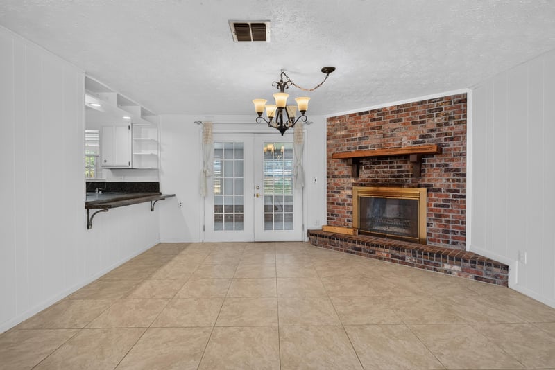 Living room fireplace and chandelier at 9954 Larkdale Ct, Jacksonville, FL 32257