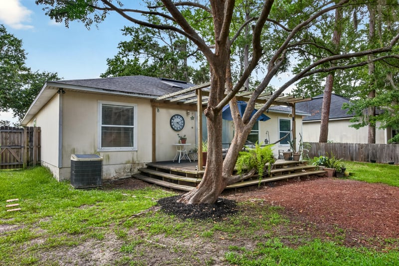 Backyard deck shaded by a large tree at 145 Dover Bluff Dr, Orange Park, FL