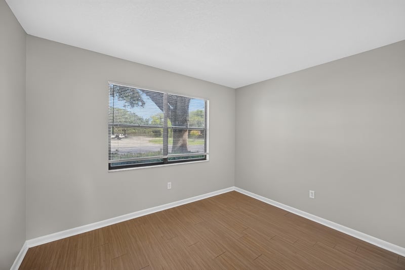 Bedroom with window and tree view at 700 W Pope Rd unit h61, St. Augustine, FL 32080
