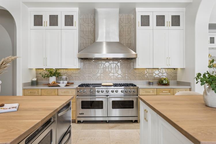 Range wall with white cabinetry and a stainless hood, Paradise Valley