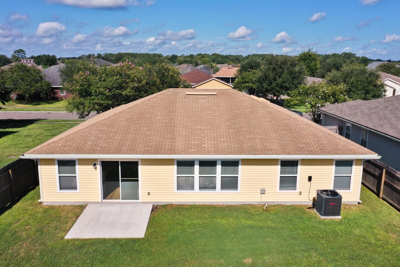 Rear exterior with patio and AC unit at 7545 Lirope St, Jacksonville, FL 32244