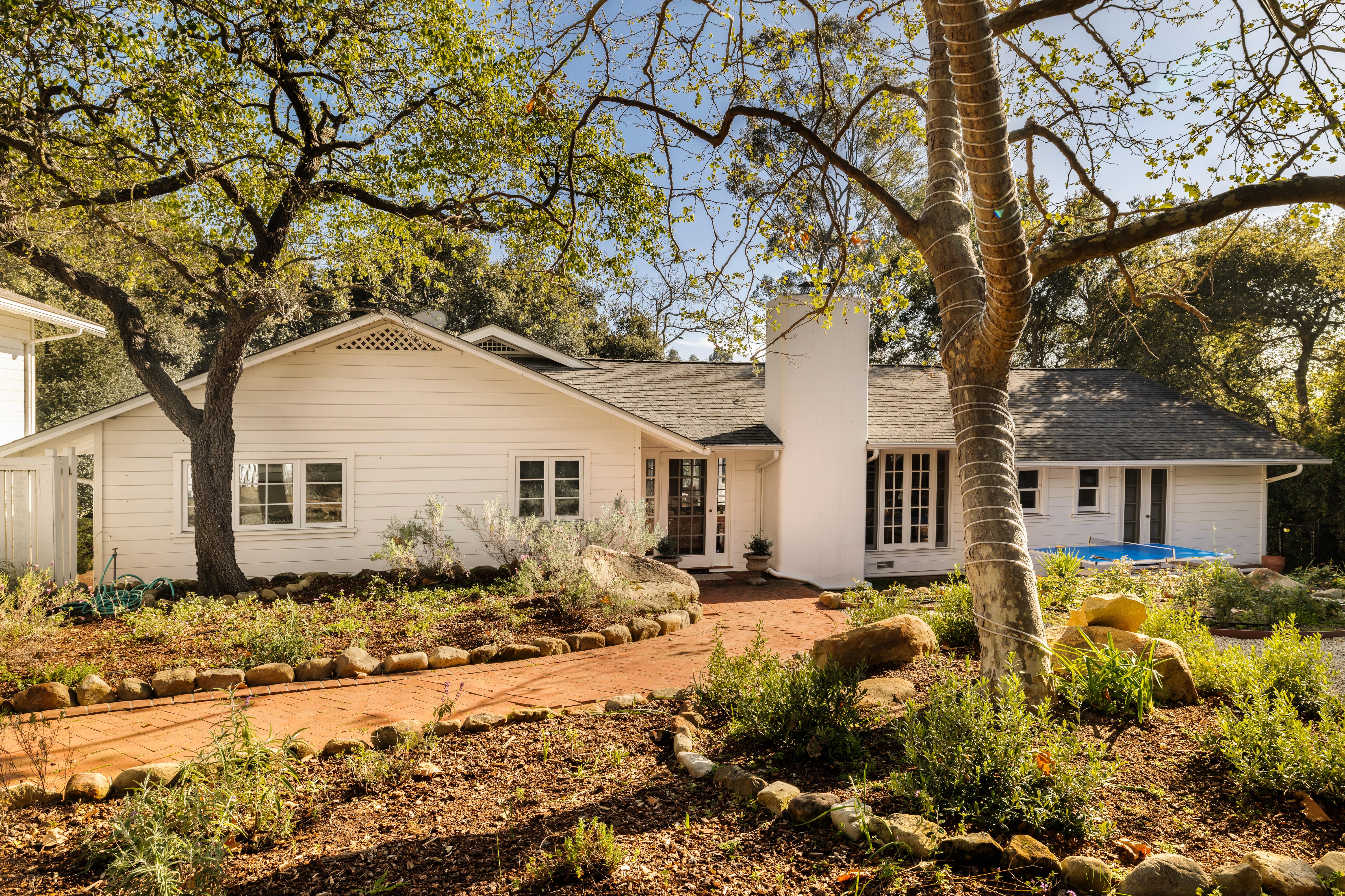 Aerial drone photography of 2915 Hidden Valley Ln, Santa Barbara CA — sweeping elevated perspective reveals the property's relationship to the surrounding Montecito foothills and mature tree canopy in this real estate drone photography series by VirTour Media. Our team captured still photography, aerial drone photography, and twilight photography from late afternoon through twilight.