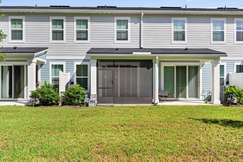 Rear exterior with screened porch and lawn at 39 Mellowood Ln, St. Augustine, FL 32092