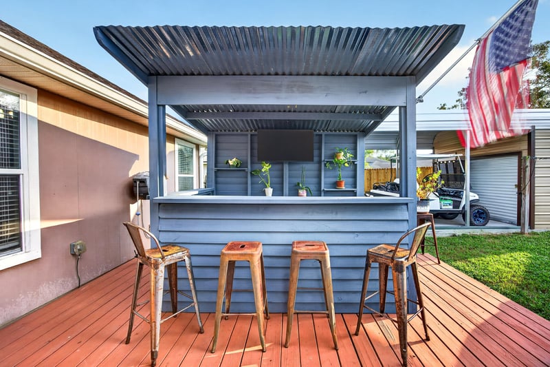 Backyard bar seating under a wood pergola at 3112 Silverado Cir, Green Cove Springs, FL 32043