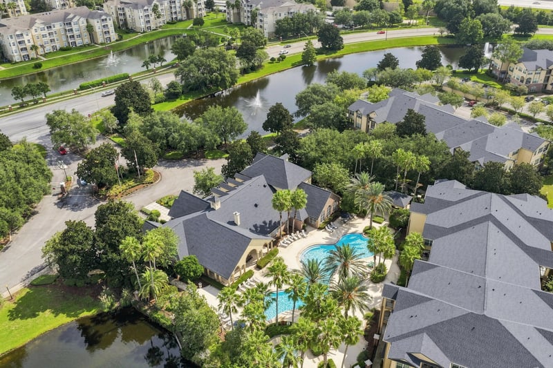 Aerial view of community buildings and a pond in Reserve at Point Meadows