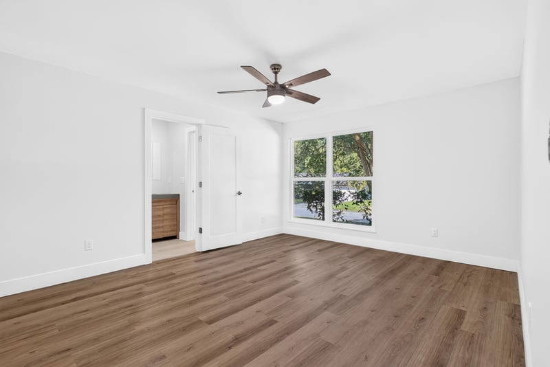Empty bedroom with wood flooring and windows at 8453 Boysenberry Ln W, Jacksonville, FL