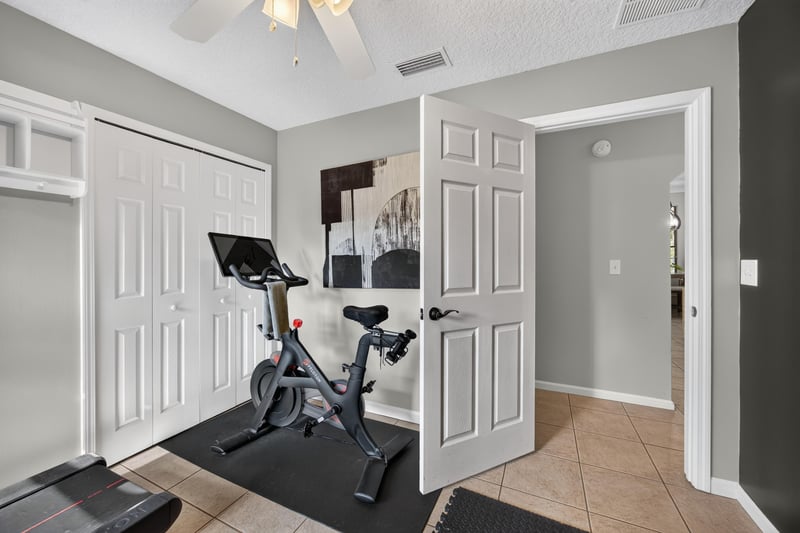 Home gym with exercise bike and closet at 2125 Blue Heron Cove Dr, Orange Park, FL 32003