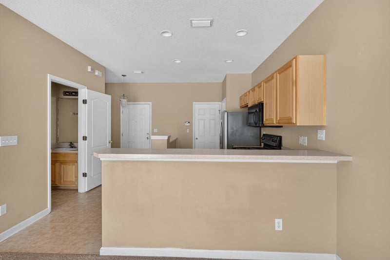 Kitchen peninsula looking toward entry at 12359 Mangrove Forest Ct, Jacksonville, FL 32218