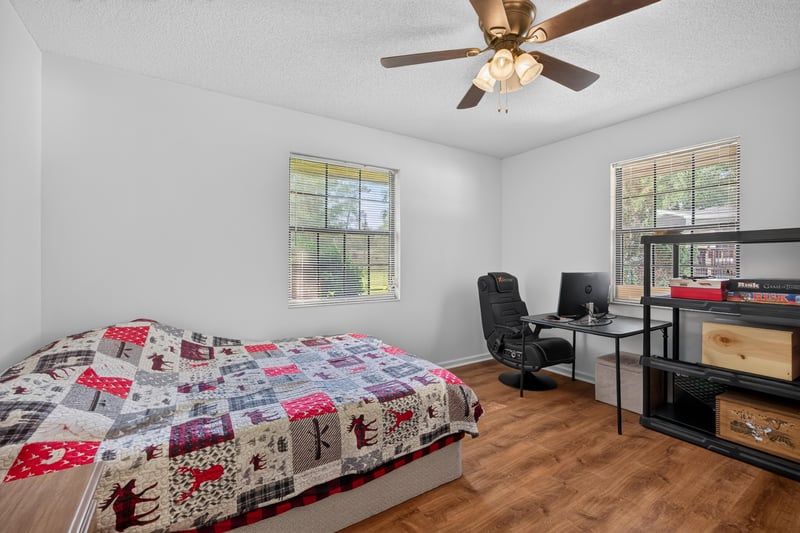 Bedroom with desk and bed at 2435 Range Line Rd, Middleburg, FL