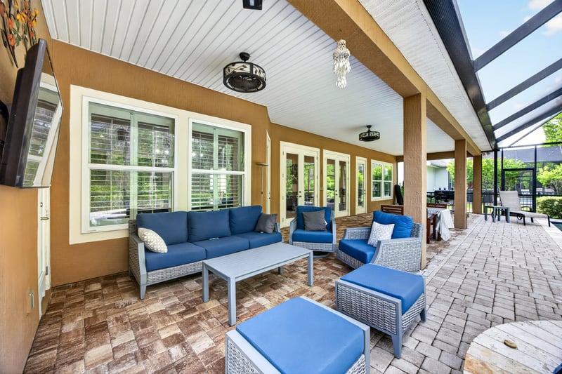 Covered patio seating area with blue cushions at 276 Cross Ridge Dr, Ponte Vedra Beach, FL 32081