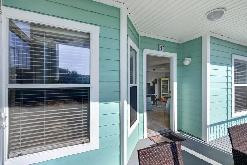 Exterior walkway with windows and teal trim at 206 16th St, St. Augustine, FL 32080