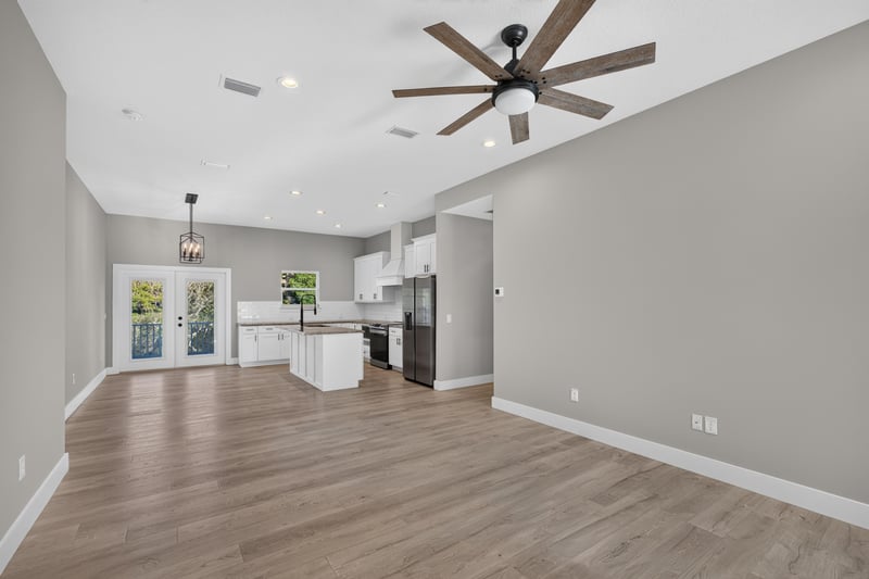 Open living area with wood floors leading to kitchen at 175 Alava Ct