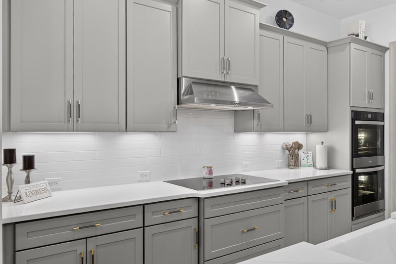 Kitchen sink and range hood with white cabinets at 785 Back Creek Dr, St. Augustine, FL 32092