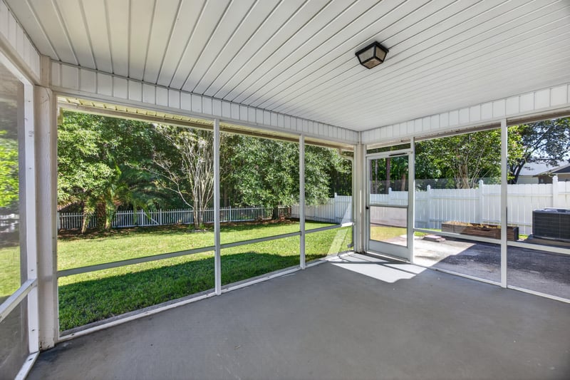 Screened porch with ceiling fan overlooking backyard at 14147 Fish Eagle Dr E, Jacksonville, FL 32226