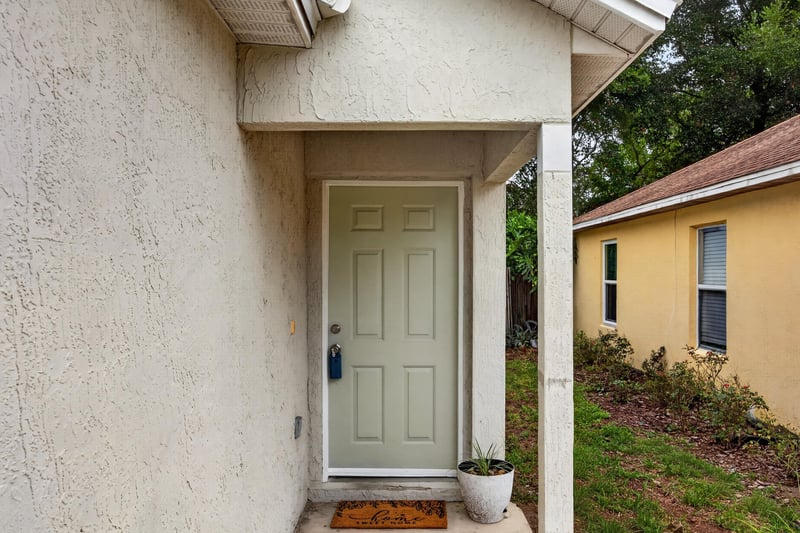 Front entry door with covered stoop at 7329 Lawn Tennis Ln, Jacksonville, FL