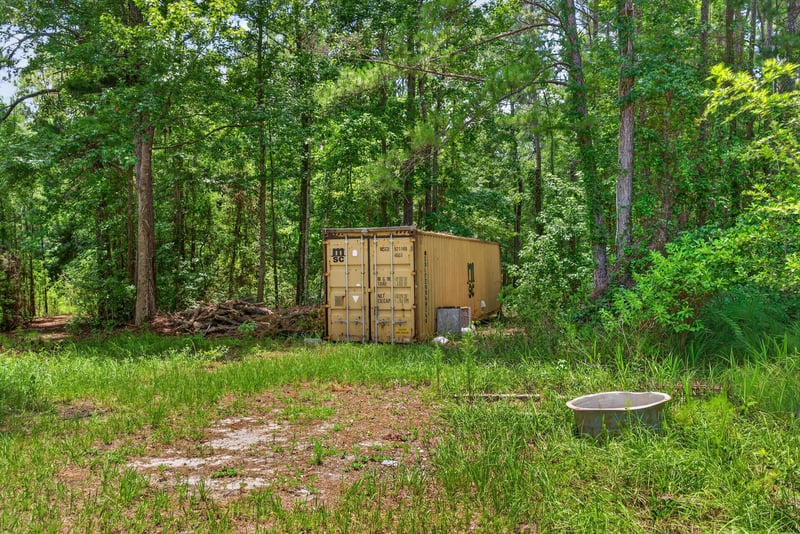 Small shed with equipment among trees at 4890 McAllister Rd, Middleburg, FL 32068