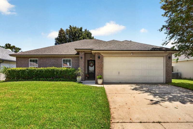 Front exterior with driveway at 1589 Backwater Drive, Middleburg, FL 32068