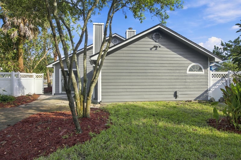 Backyard with trees and patio at 678 5th Ave N, Jacksonville Beach, FL 32250