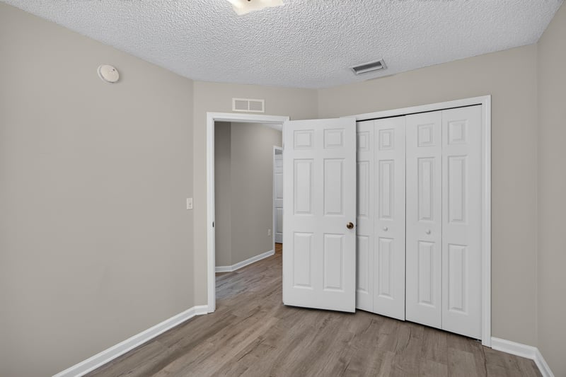 Bedroom with double closet doors at 8519 Blazing Star Ct, Jacksonville, FL 32210