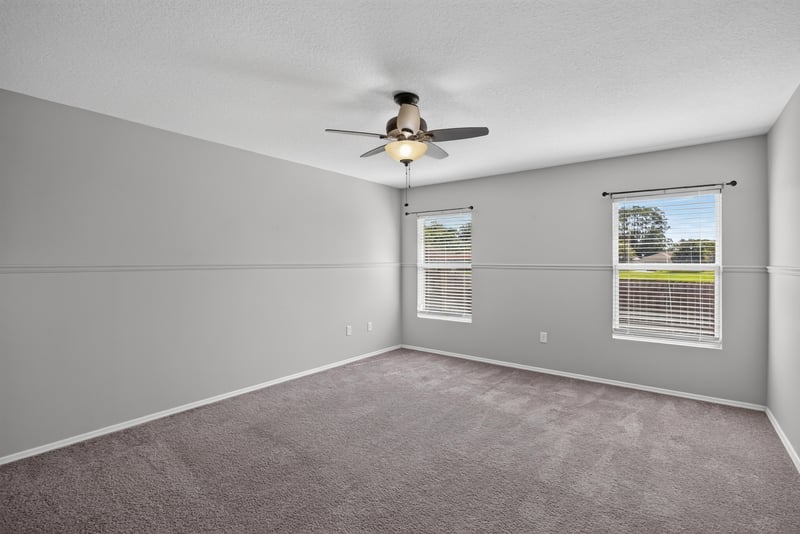Empty bedroom with carpet and ceiling fan at 7545 Lirope St, Jacksonville, FL 32244