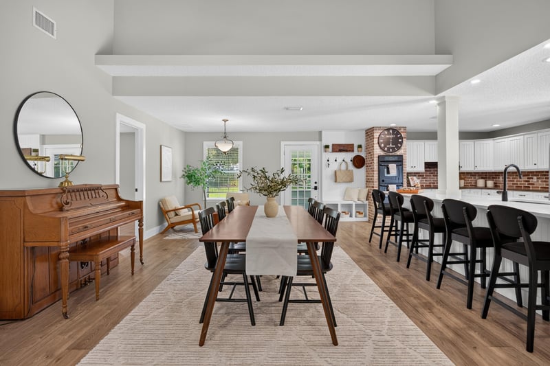 Dining area with piano and open living room at 1161 Whispering Pines Rd, Jacksonville, FL 32259