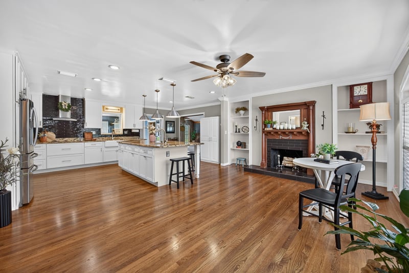 Open living area with wood floors and fireplace at 5843 Ovella Rd, Jacksonville, FL 32244