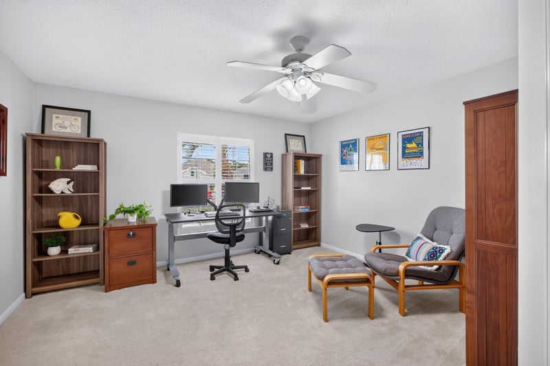 Home office with two desks and shelving at 11225 Water Spring Cir, Jacksonville, FL 32256
