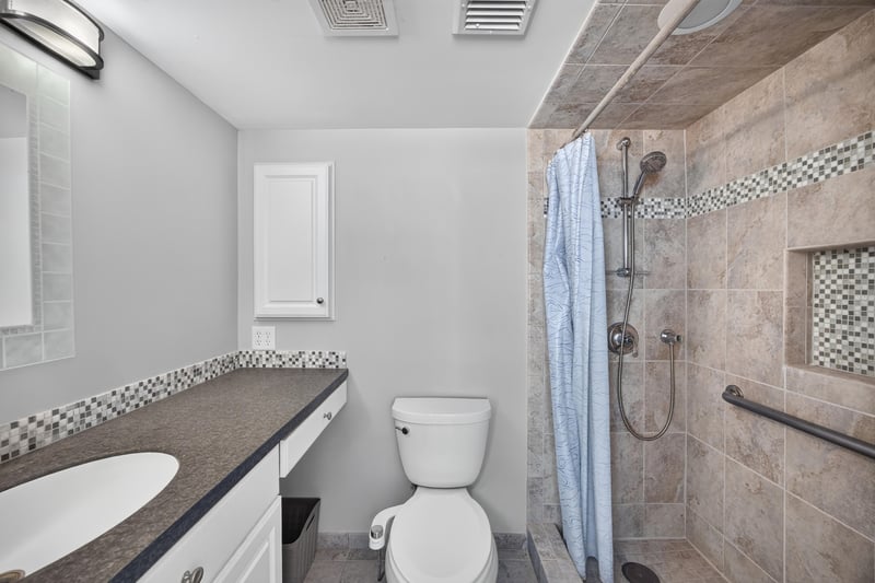 Bathroom with tile shower and vanity at 601 1st St S, Jacksonville Beach