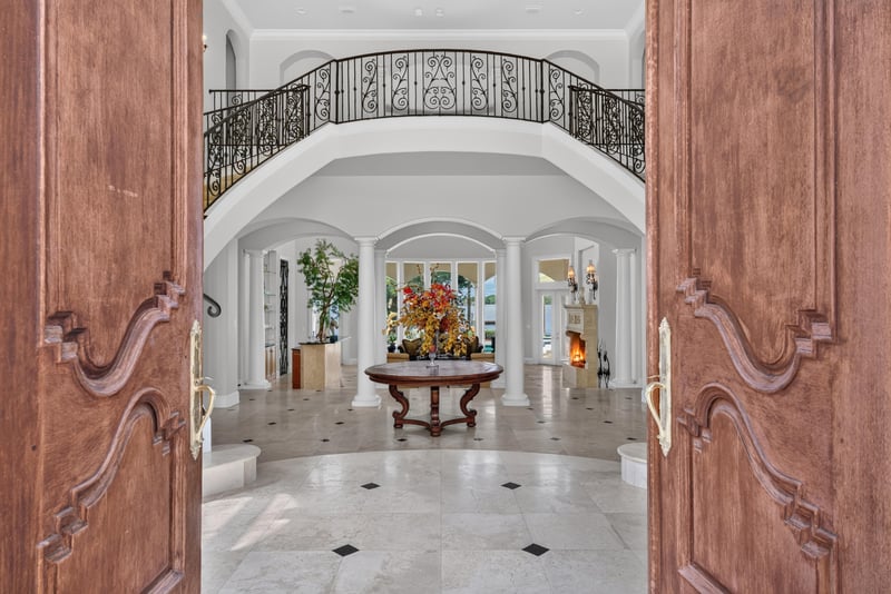 Entry foyer with wood double doors open to the staircase hall at 344 Broward Rd, Jacksonville, FL