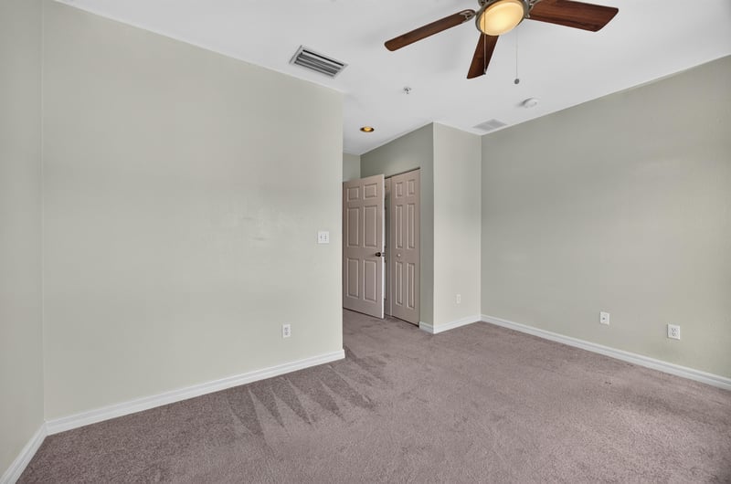 Bedroom with ceiling fan and closet doors at 342 E Ashley St, Jacksonville, FL 32202