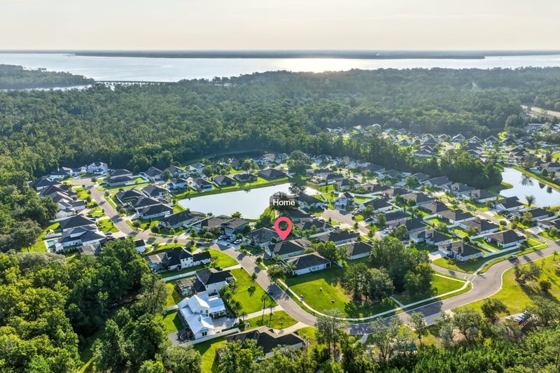 Aerial view of the neighborhood and lake near the home in Green Cove Springs, FL