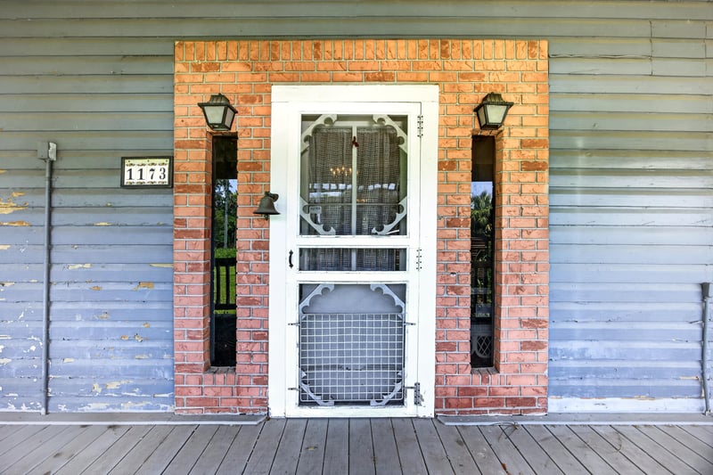 Front door with brick surround and house numbers at 1173 US-17, Satsuma, FL 32189