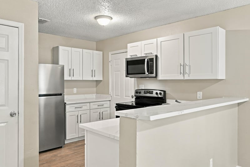Kitchen with stainless refrigerator and white cabinetry at 219 Shortreed St, Jacksonville, FL 32254