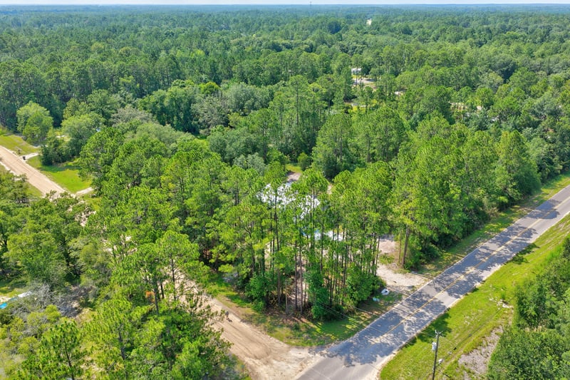 Aerial view of the wooded street and surrounding land in Middleburg, FL