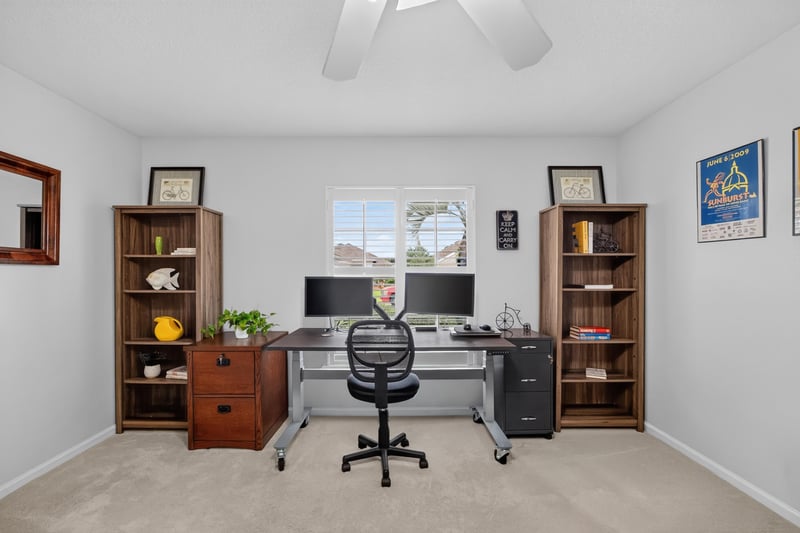 Home office with built-in bookcases and desks at 11225 Water Spring Cir, Jacksonville, FL 32256