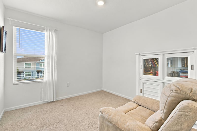 Upstairs flex room with sofa and windows at 8359 Zenith Cir, Jacksonville, FL 32256
