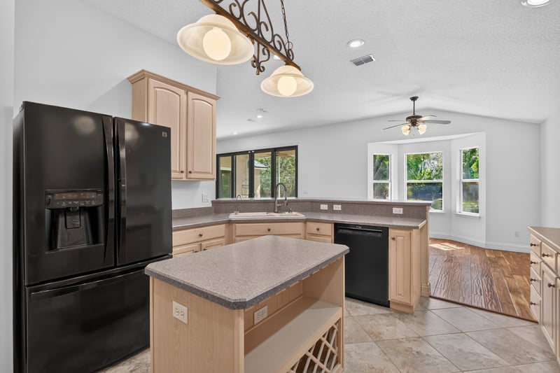 Kitchen island with dishwasher and pendant lights at 11675 Magnolia Estates Rd, Jacksonville, FL 32223