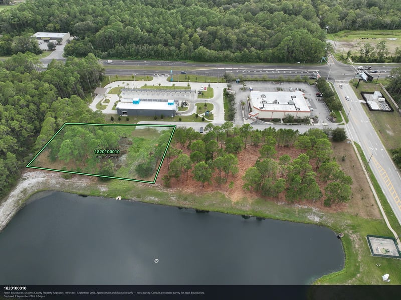 Aerial view of the pond and wooded parcel with highway edge at 4900 US-1, St. Augustine, FL 32086