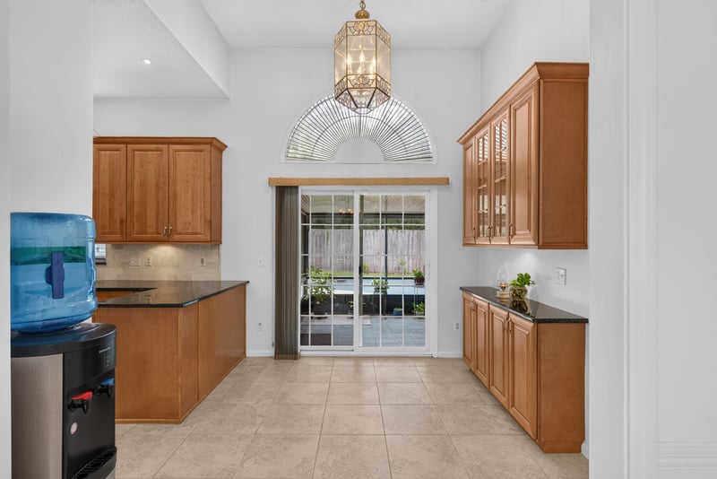 Kitchen cabinets with sliding door to pool at 12810 Swamp Owl Ln