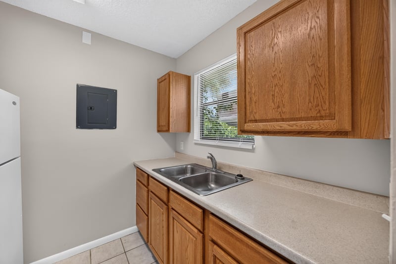 Kitchen sink and countertop with wood cabinets at 2717 Trollie Ln, Jacksonville, FL