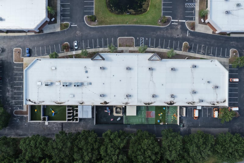 Aerial view of a building roof edge with parking lot at 10550 Deerwood Park Blvd, Jacksonville, FL 32256