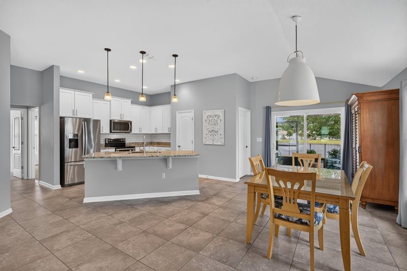 Kitchen island with pendant lighting and dining table at 85 Amia Dr, St. Augustine, FL 32086