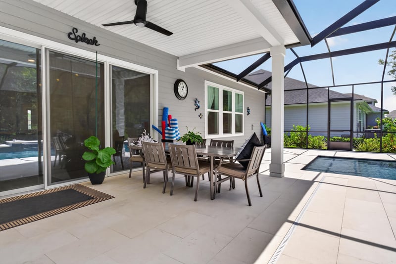 Covered lanai seating area overlooking the pool at 785 Back Creek Dr, St. Augustine, FL 32092
