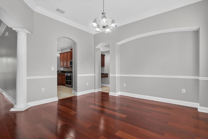 Dining area with wood floors and columned entry at 4109 Eagle Landing Pkwy, Orange Park, FL 32065
