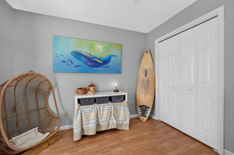 Bedroom with surfboard decor and closet at 4556 Shaky Leaf Ln N, Jacksonville, FL 32224