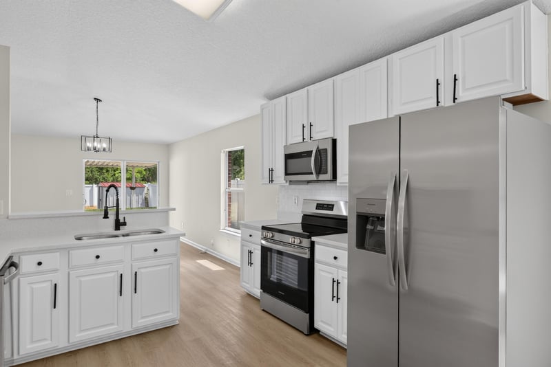 Kitchen with white cabinets and stainless appliances at 224 Pine Arbor Cir, St. Augustine, FL 32084
